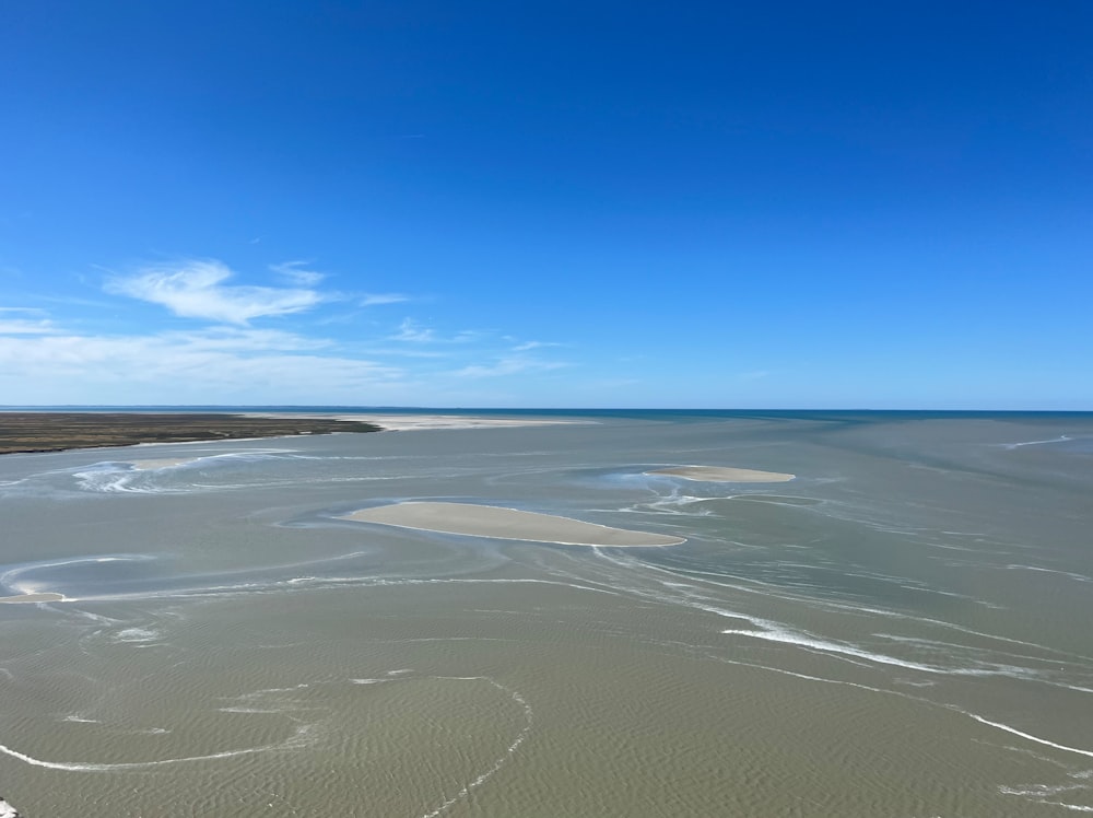 a large flat area with a body of water in the distance