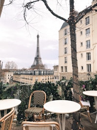 A cozy Parisian café terrace at sunset, inviting casual meetings.