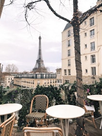 Elegant family enjoying a quiet afternoon at a Parisian café terrace with soft golden light.