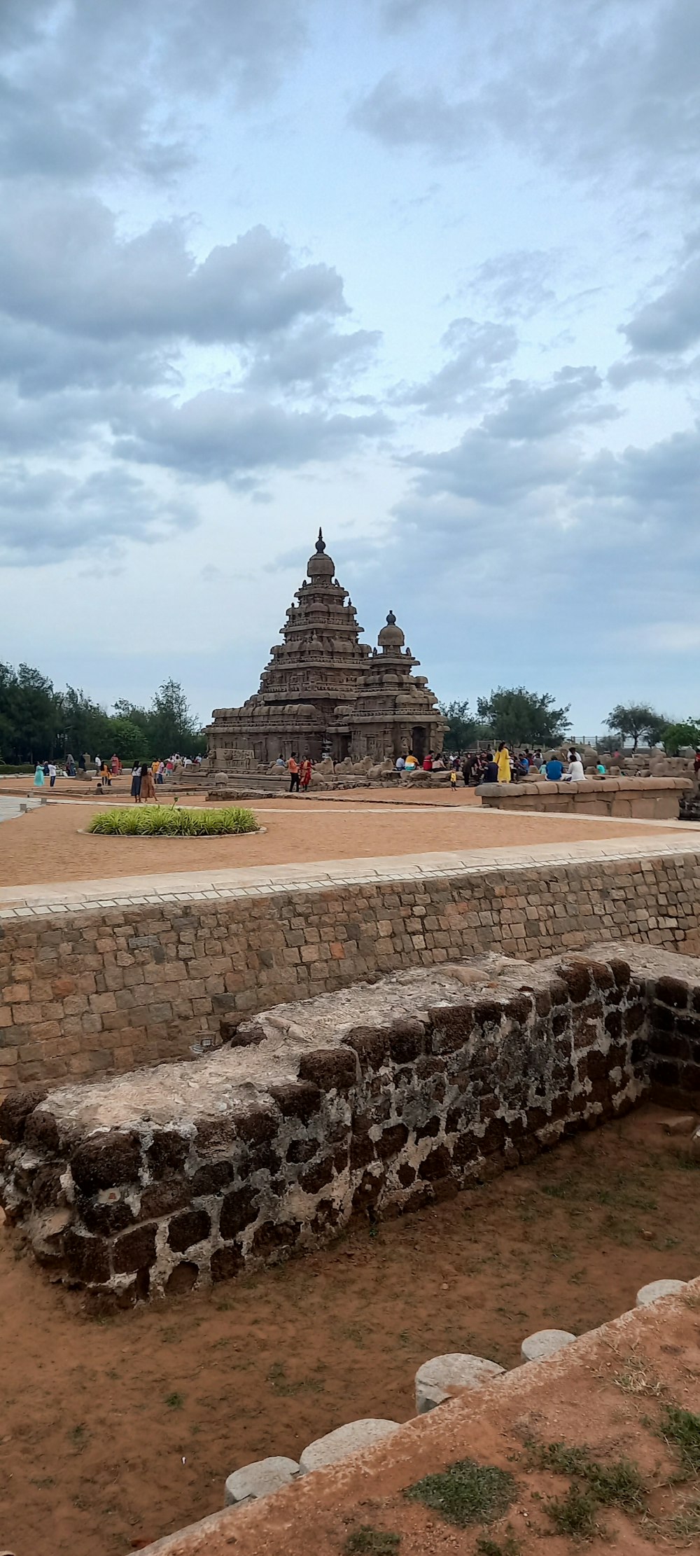 a large pyramid with people around it