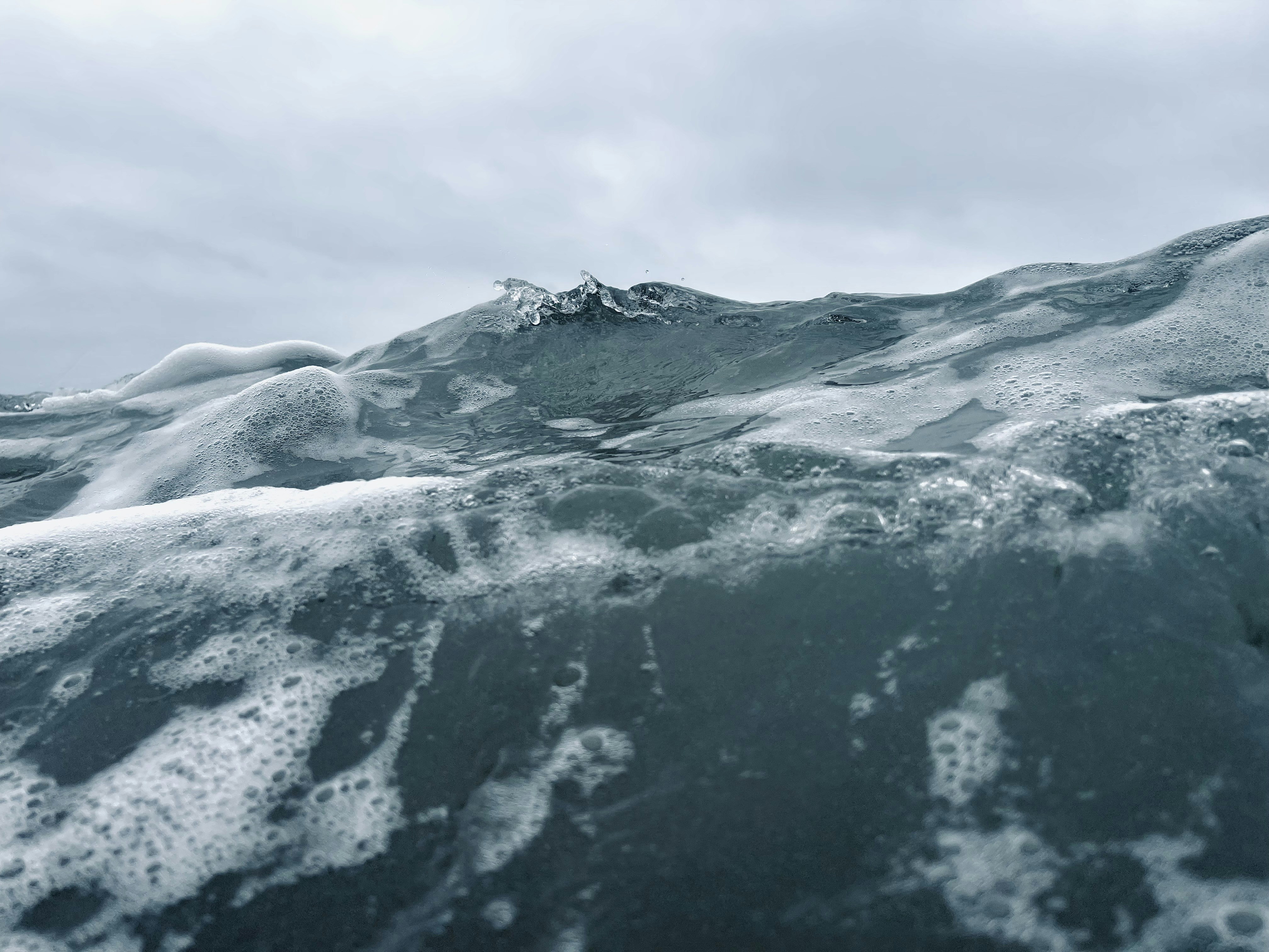 a large body of water with ice and snow on it