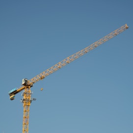 a yellow crane with a blue sky