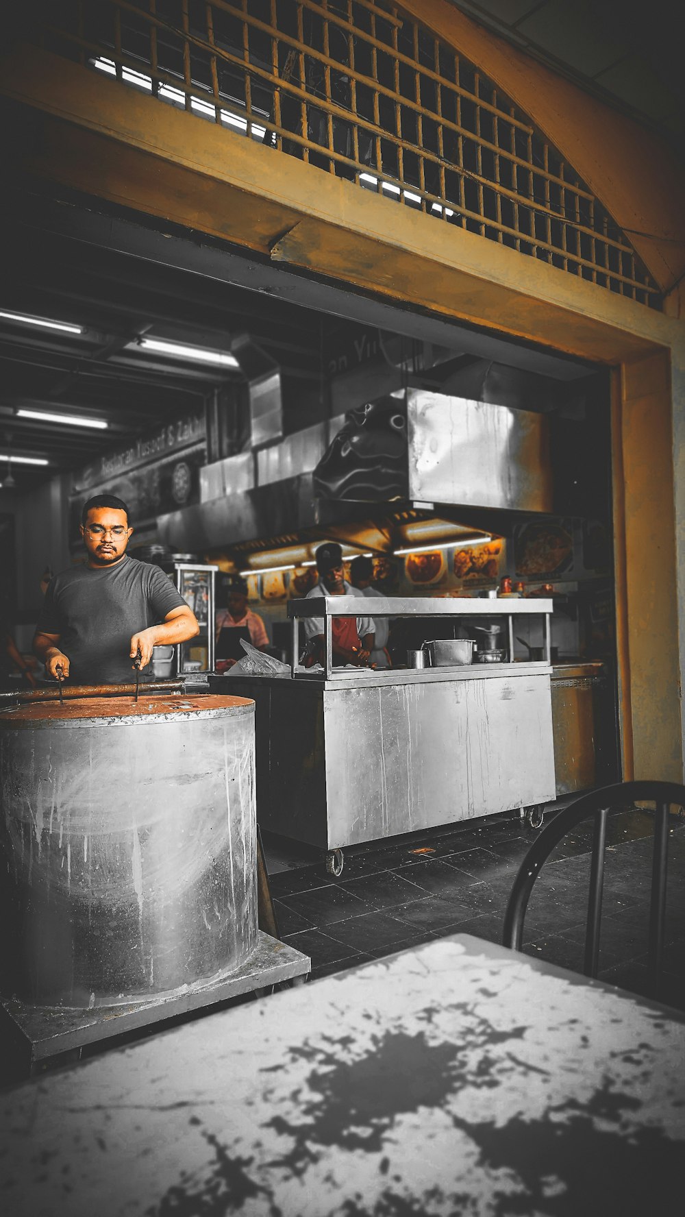 a group of people cooking in a kitchen