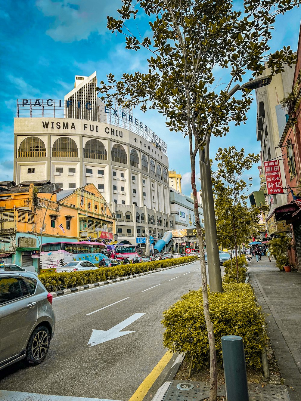 a street with cars and buildings on the side