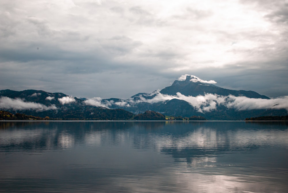 a body of water with mountains in the background