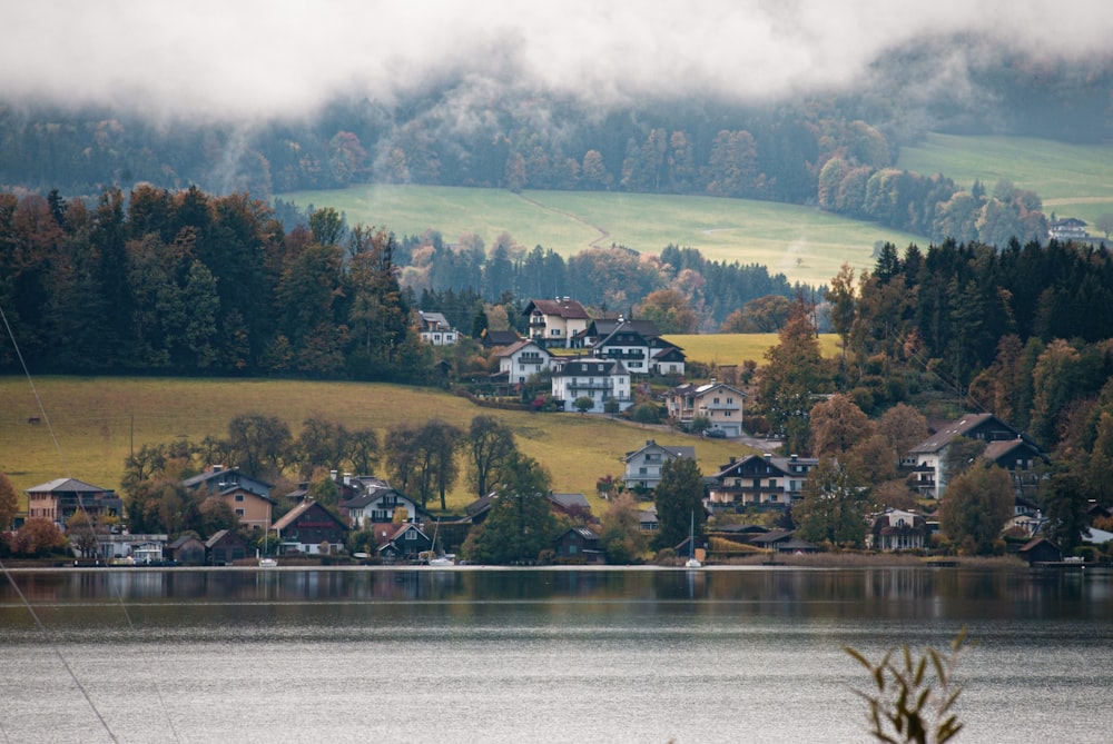 a town on a hill by a lake