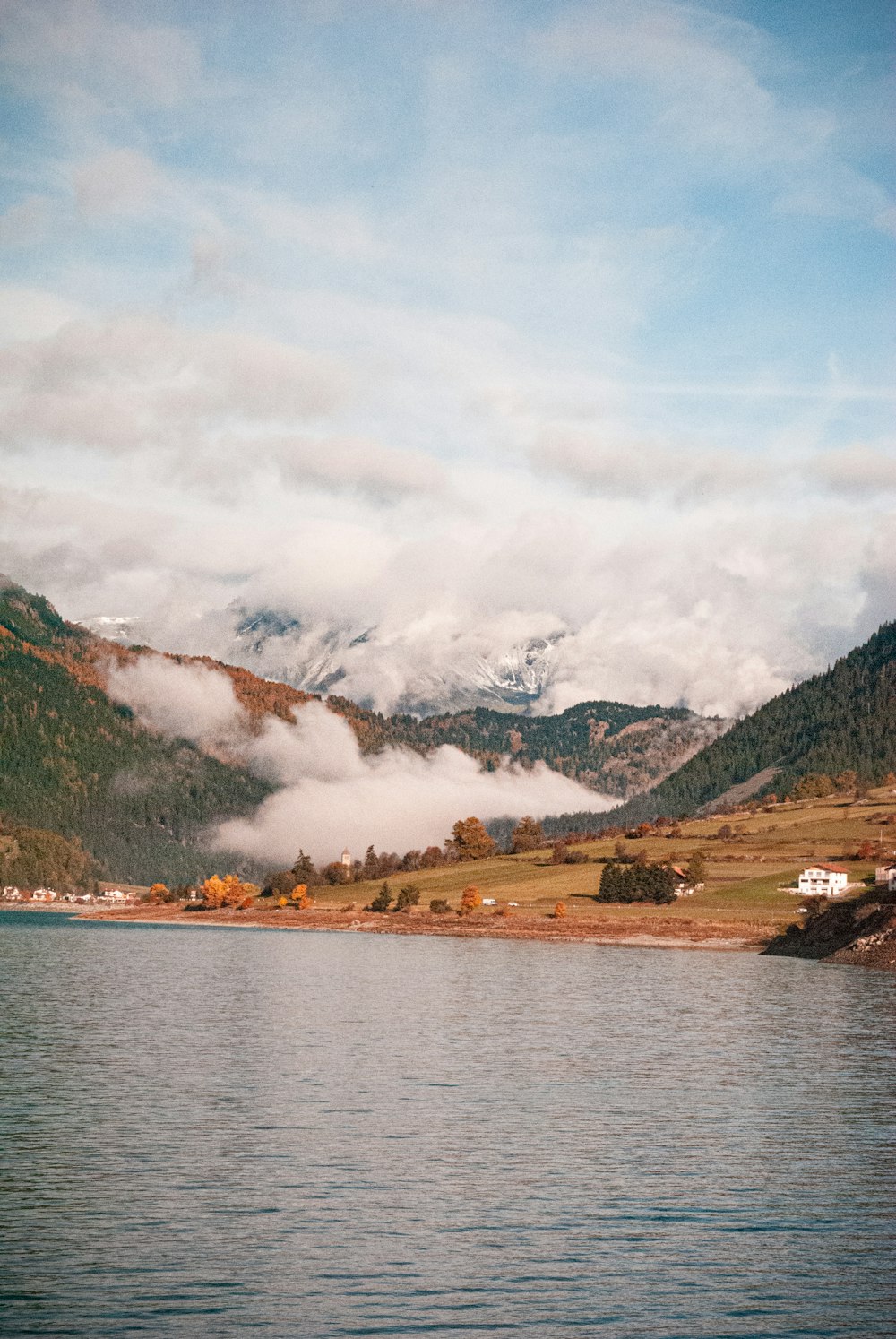 a body of water with mountains in the back