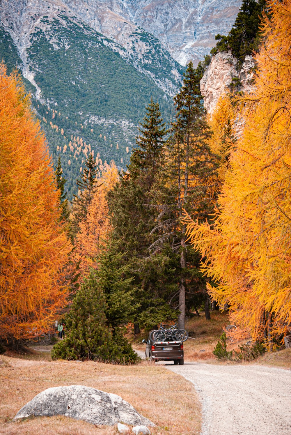 a truck parked on a road in front of a mountain