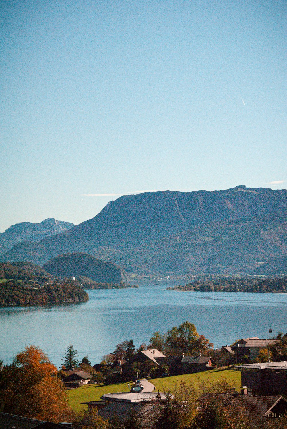 a body of water with buildings and trees around it