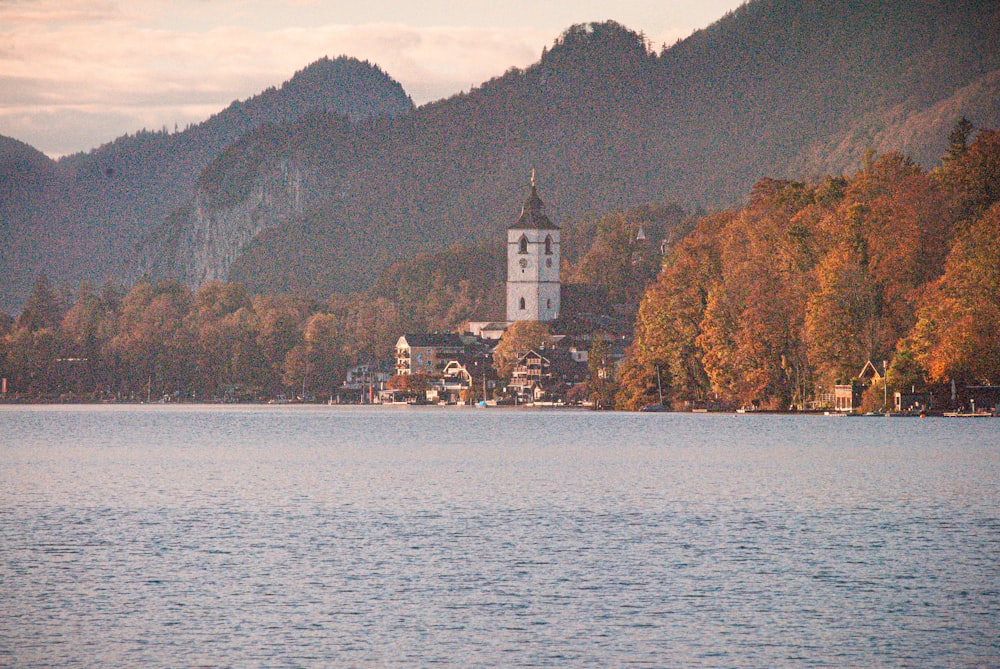 a building on a hill by a body of water