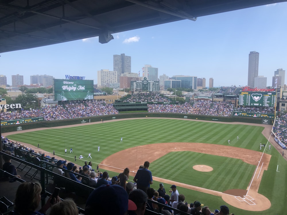 a baseball stadium with a full crowd with Wrigley Field in the background