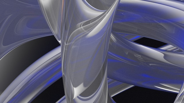 A complex arrangement of intertwining, smooth, metallic-looking shapes with a sleek, glossy finish. The design features reflective surfaces and subtle hints of blue intermixed with silver and gray tones, giving it a futuristic and abstract appearance.