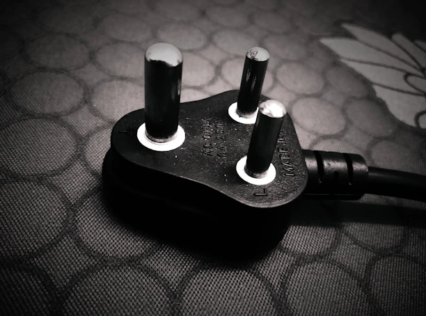 Close-up of a modern 220V electrical outlet installed on a clean wall.