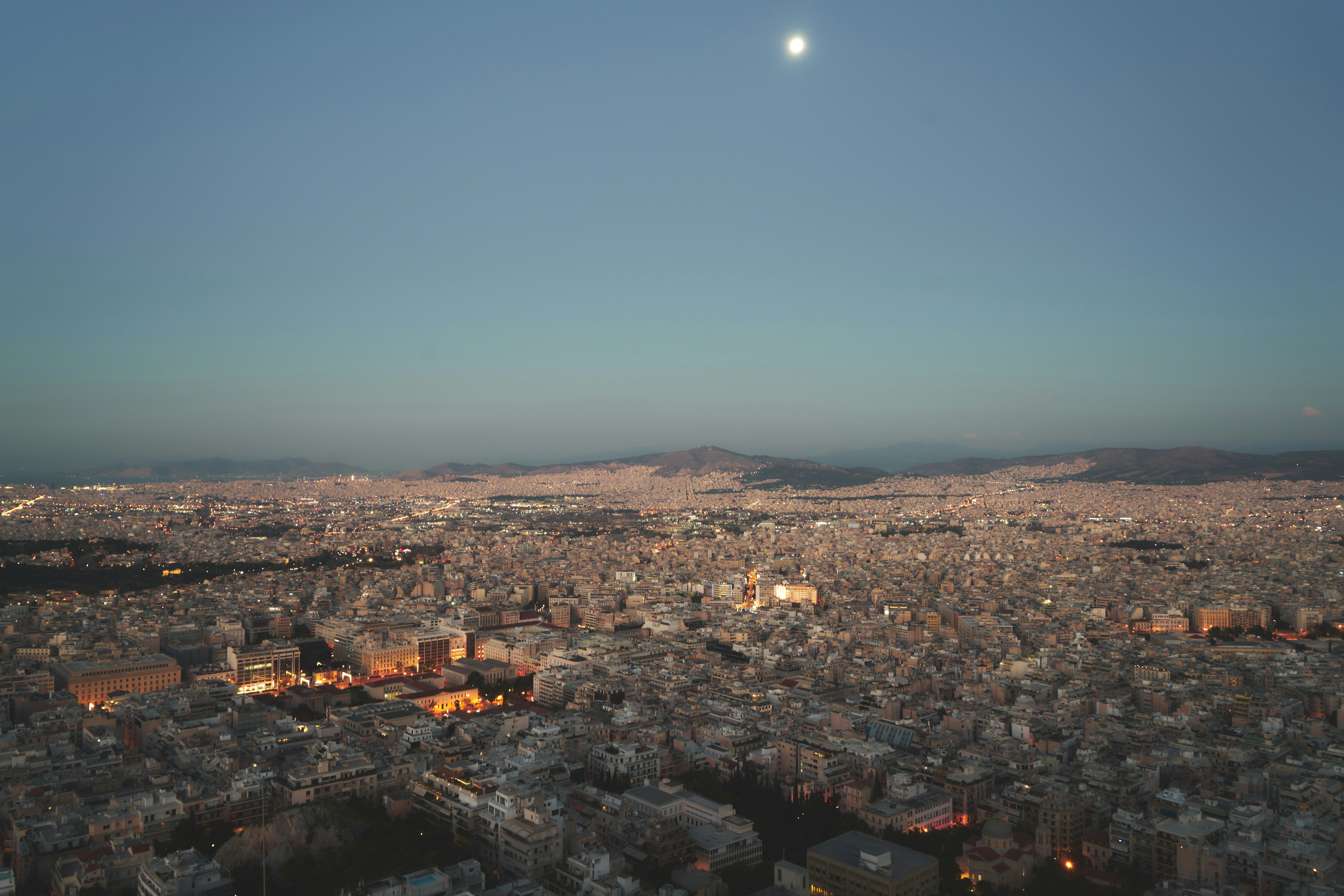 a city with a moon in the sky
