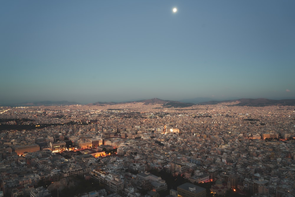 a city with a moon in the sky