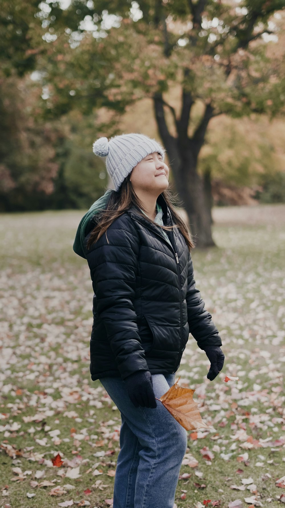 a person wearing a beanie and walking in a park