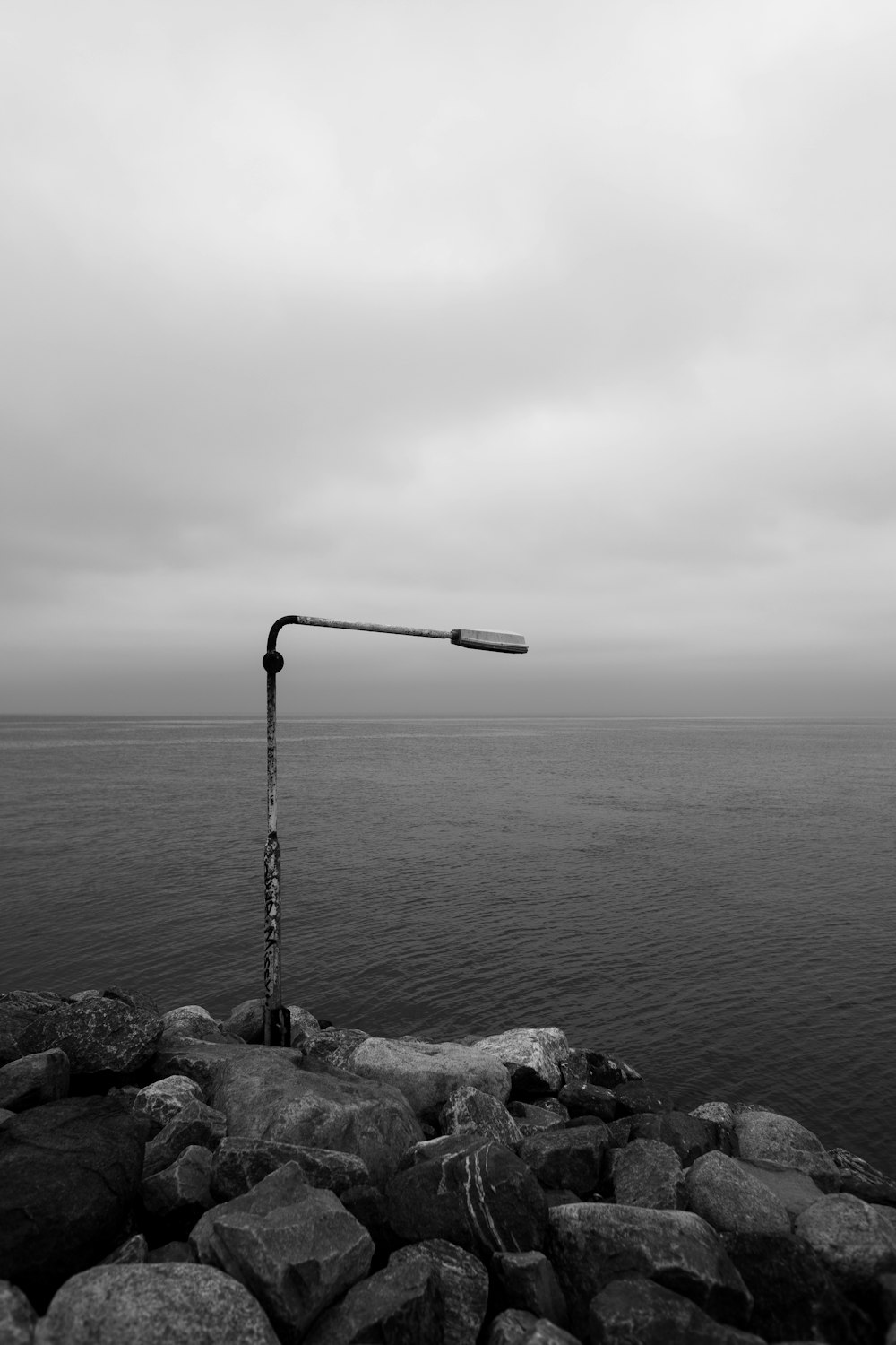 a fishing pole on a rocky shore