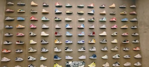 An eye-catching display of colorful sneakers on a city sidewalk.