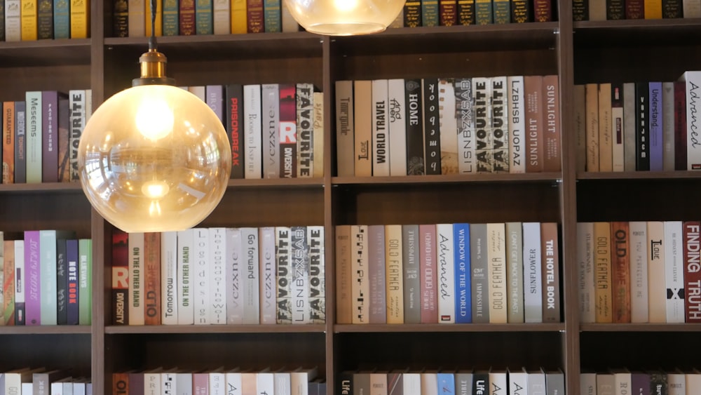 a book shelf with a lamp and books on it