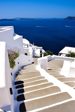 a white staircase leading down to a body of water