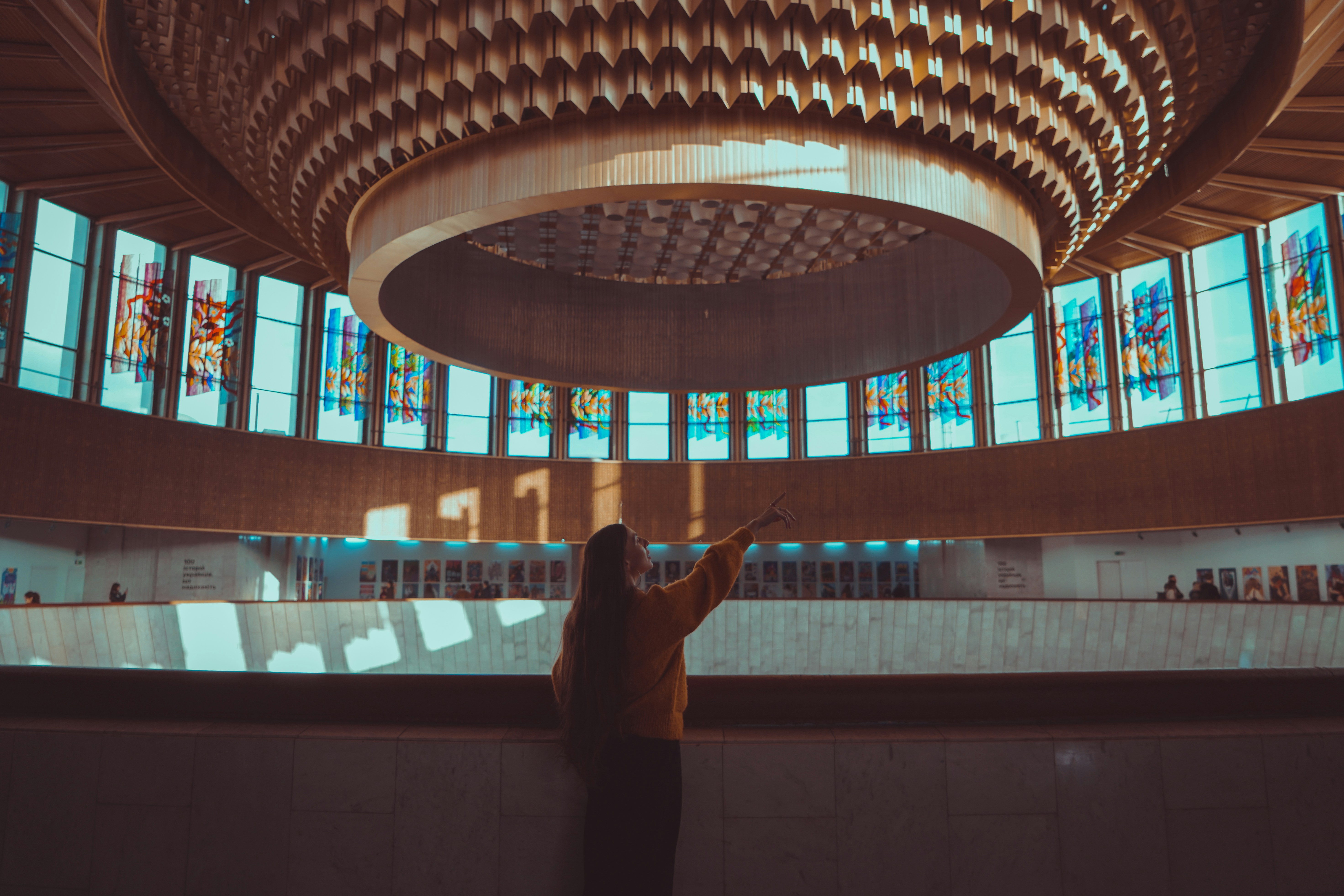 a person standing in front of a large stained glass window