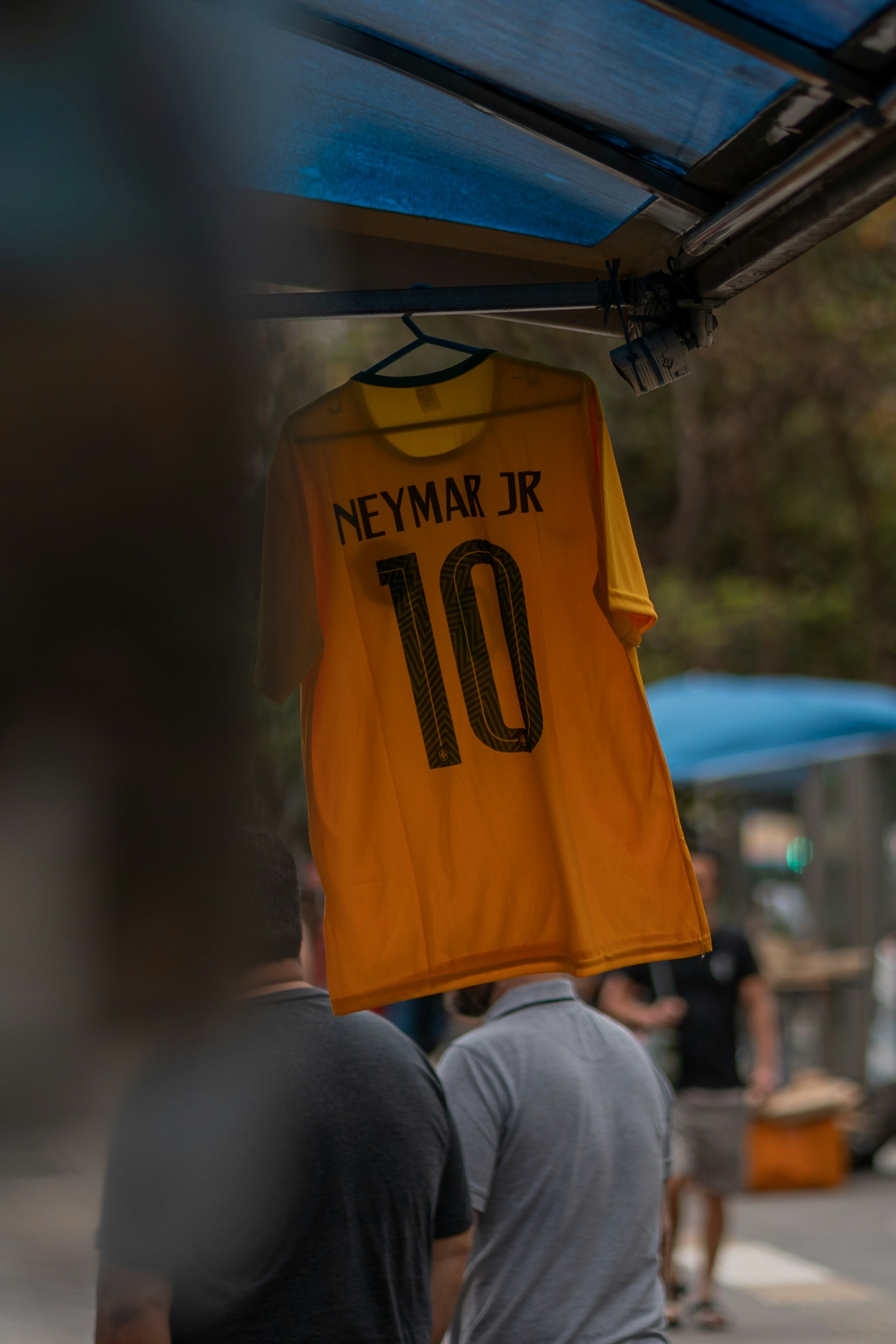 a yellow shirt from a metal pole