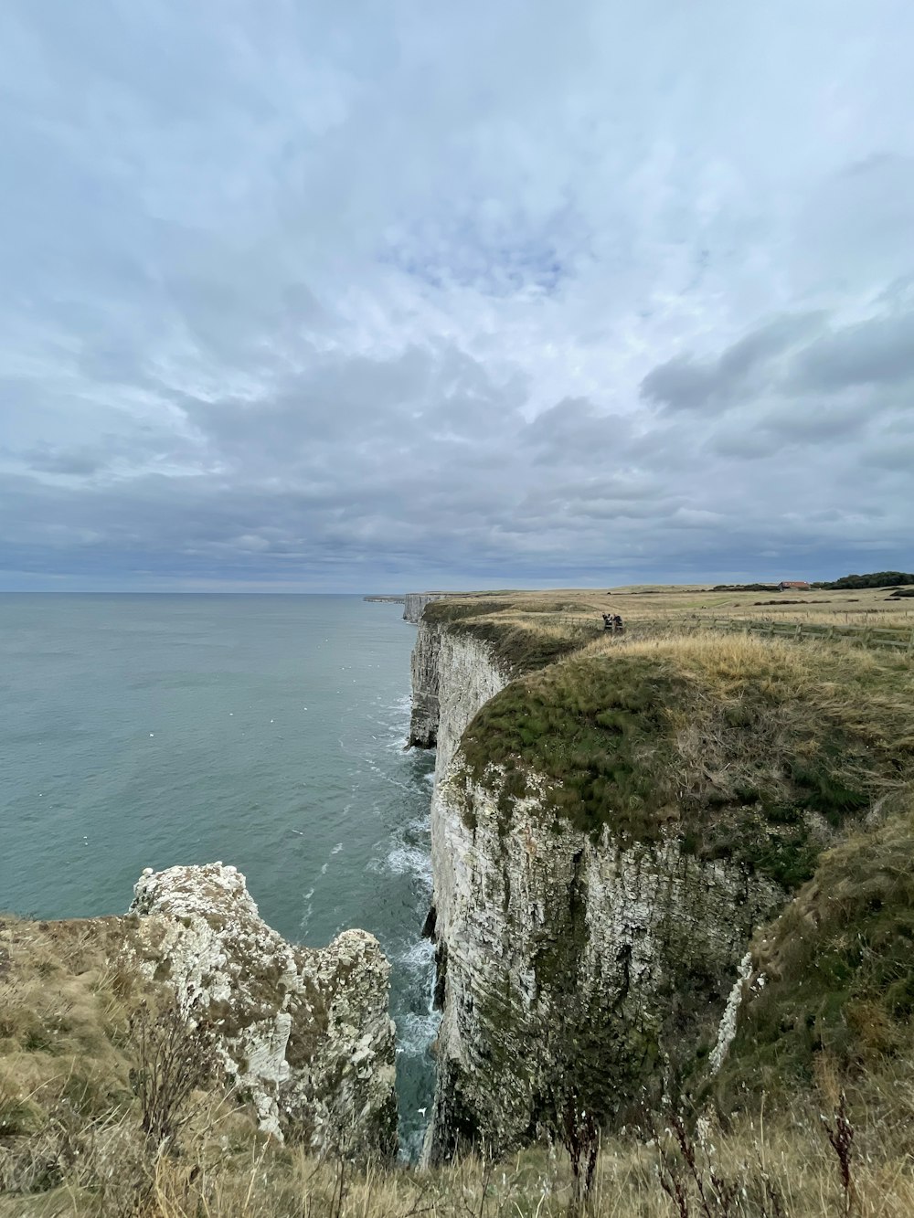 a cliff side with a body of water below