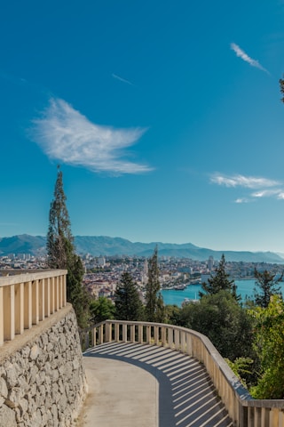 a view of a city and the water from a balcony