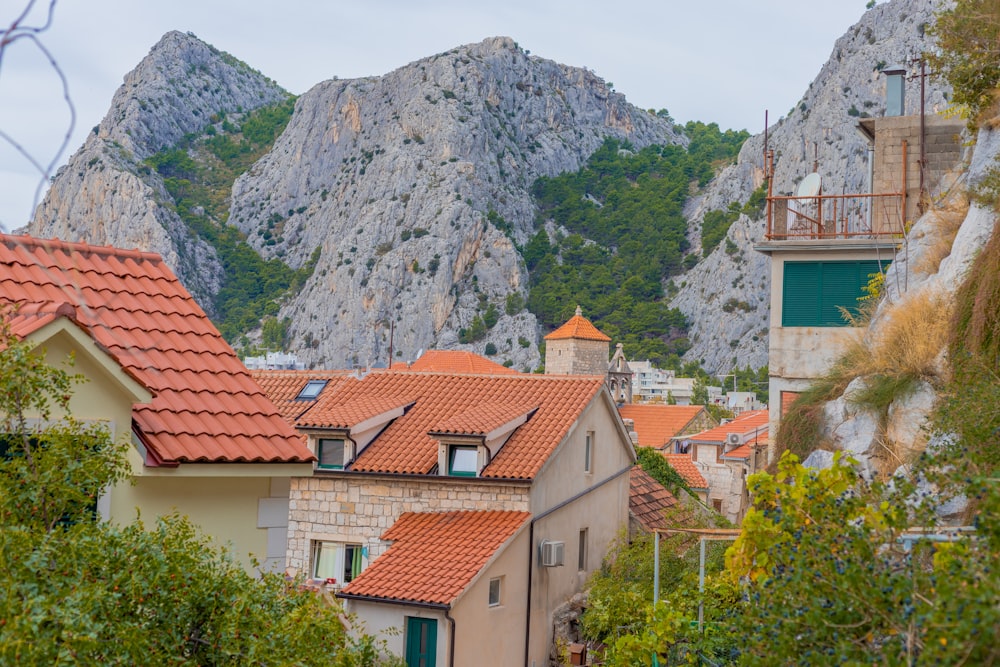 a group of buildings with mountains in the background