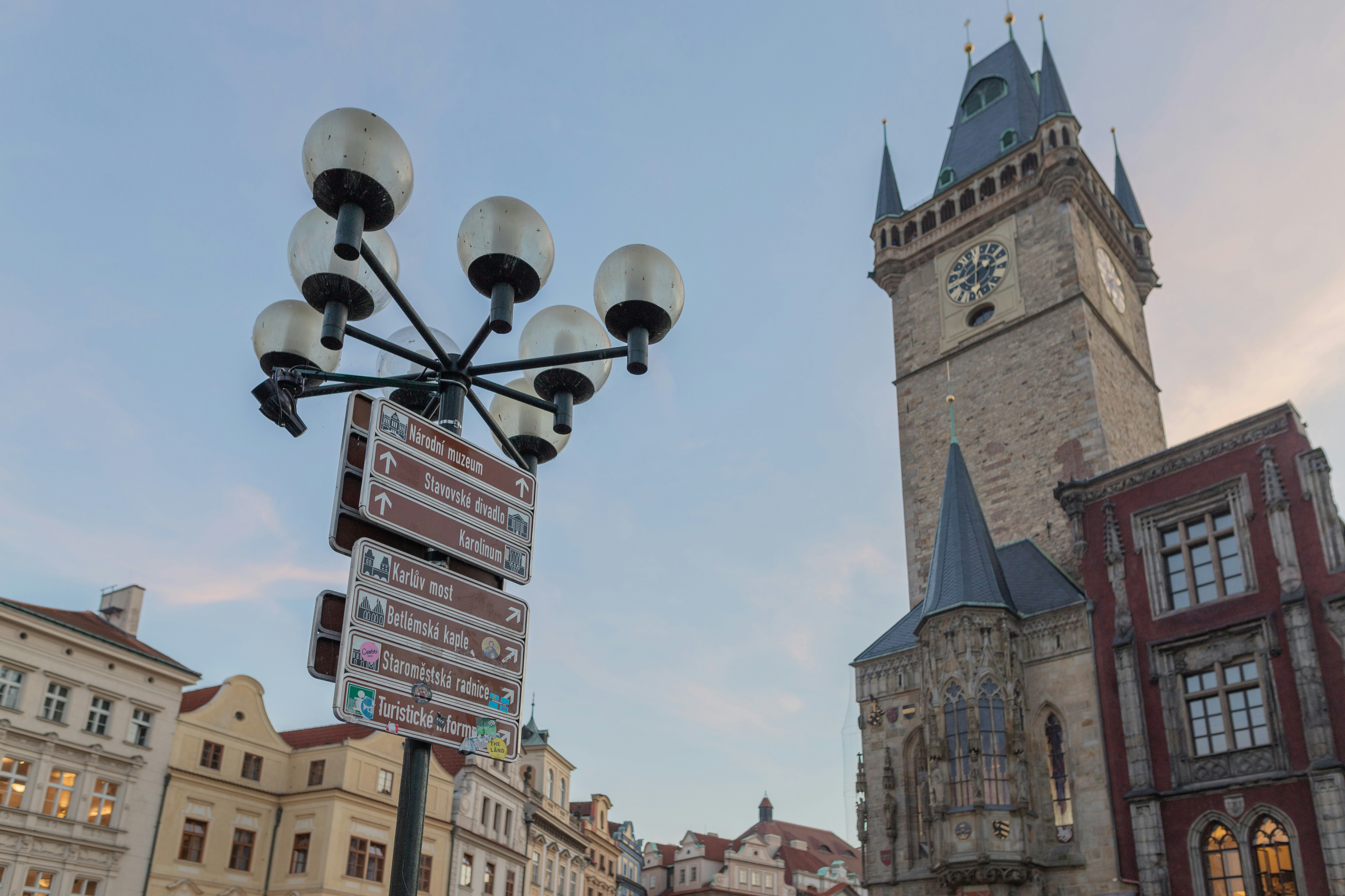a clock tower next to a street sign