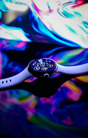 Futuristic smartwatch glowing with neon blue highlights in a broken grid layout.