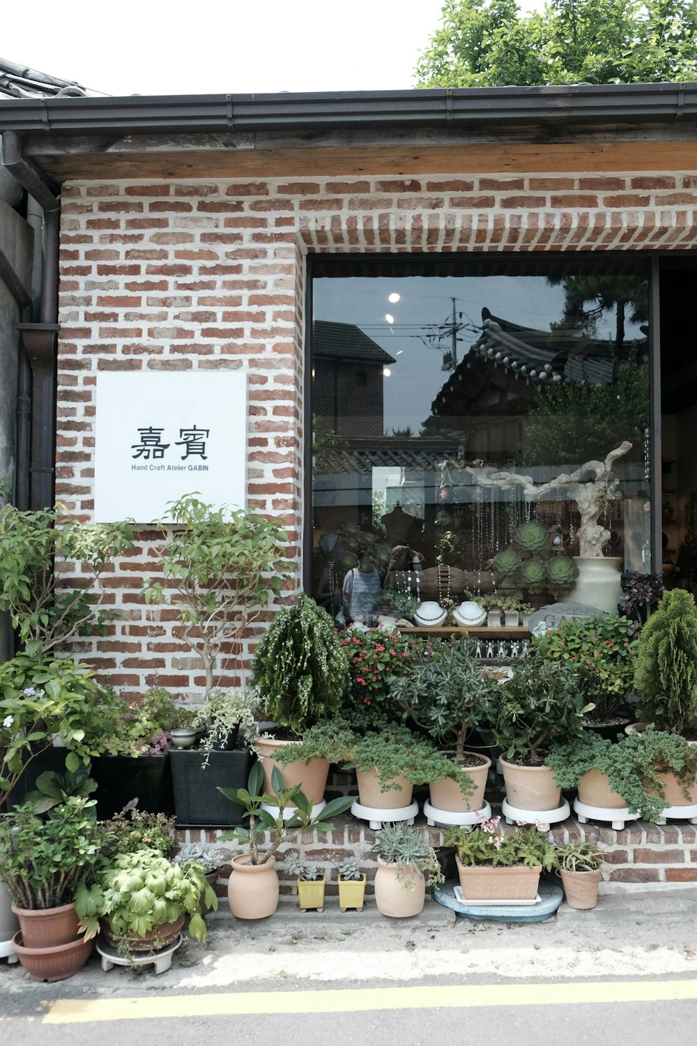 a brick building with potted plants