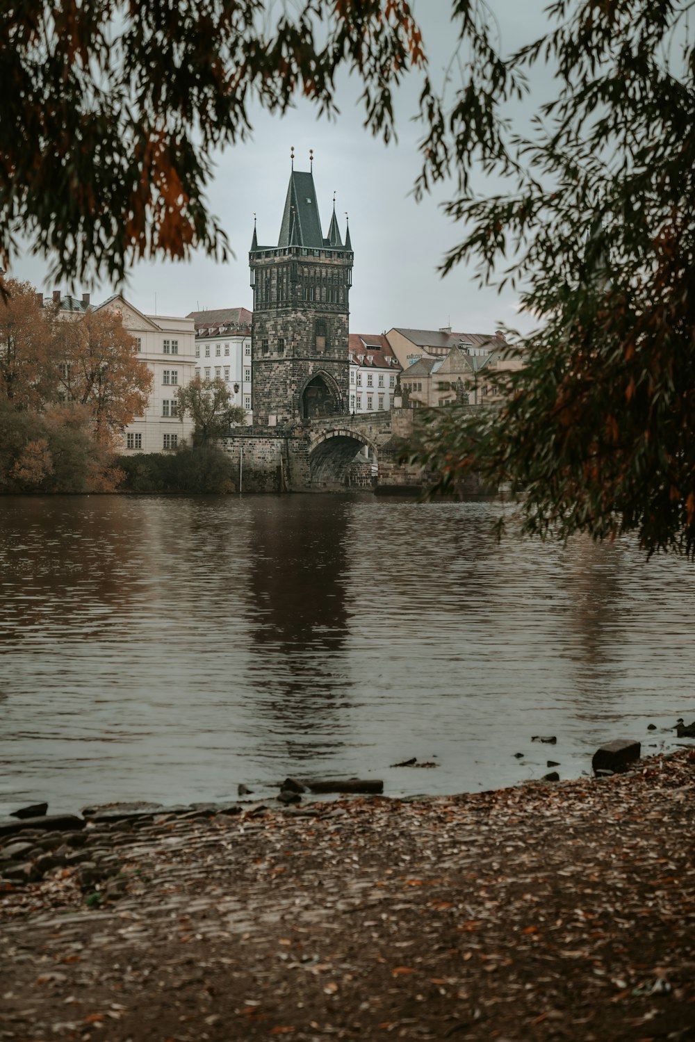 a river with a bridge and buildings along it