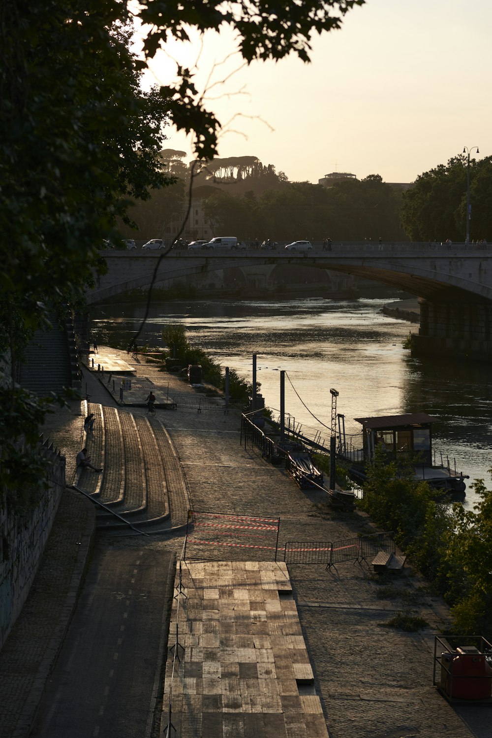 a river with a bridge and trees