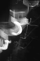 Abstract representation of data-driven innovation with swirling light trails on black.