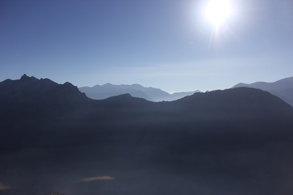 a view of the mountains and the sun