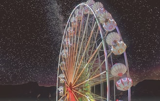 A vibrant zodiac wheel glowing under a starry night sky.