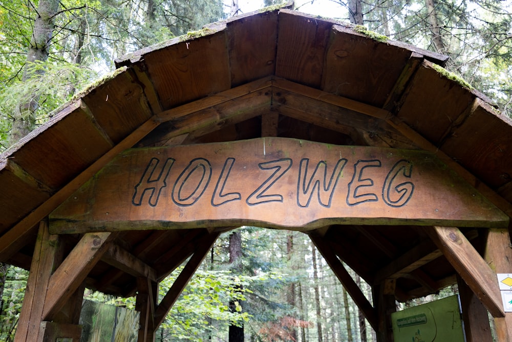 a wooden sign on a wooden structure