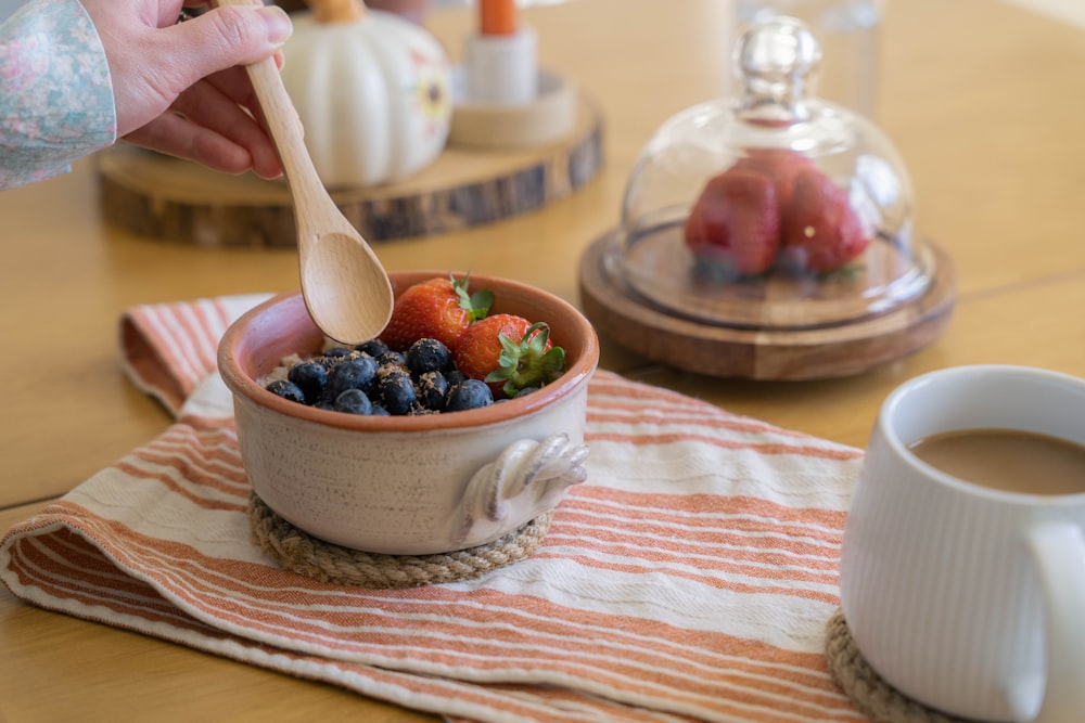 a bowl of fruit and a spoon