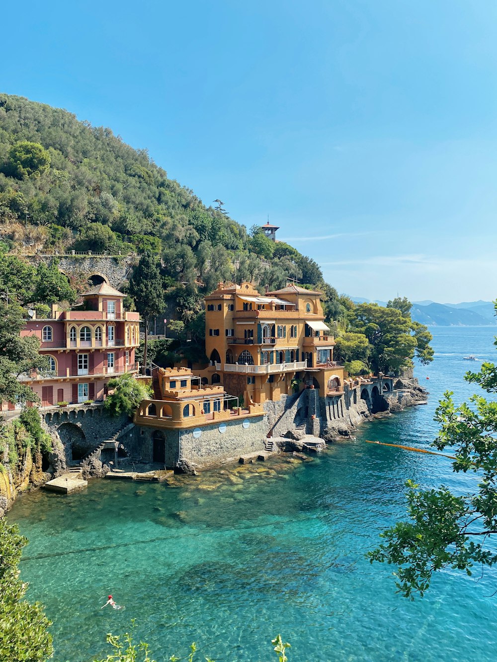 a body of water with buildings and trees around it