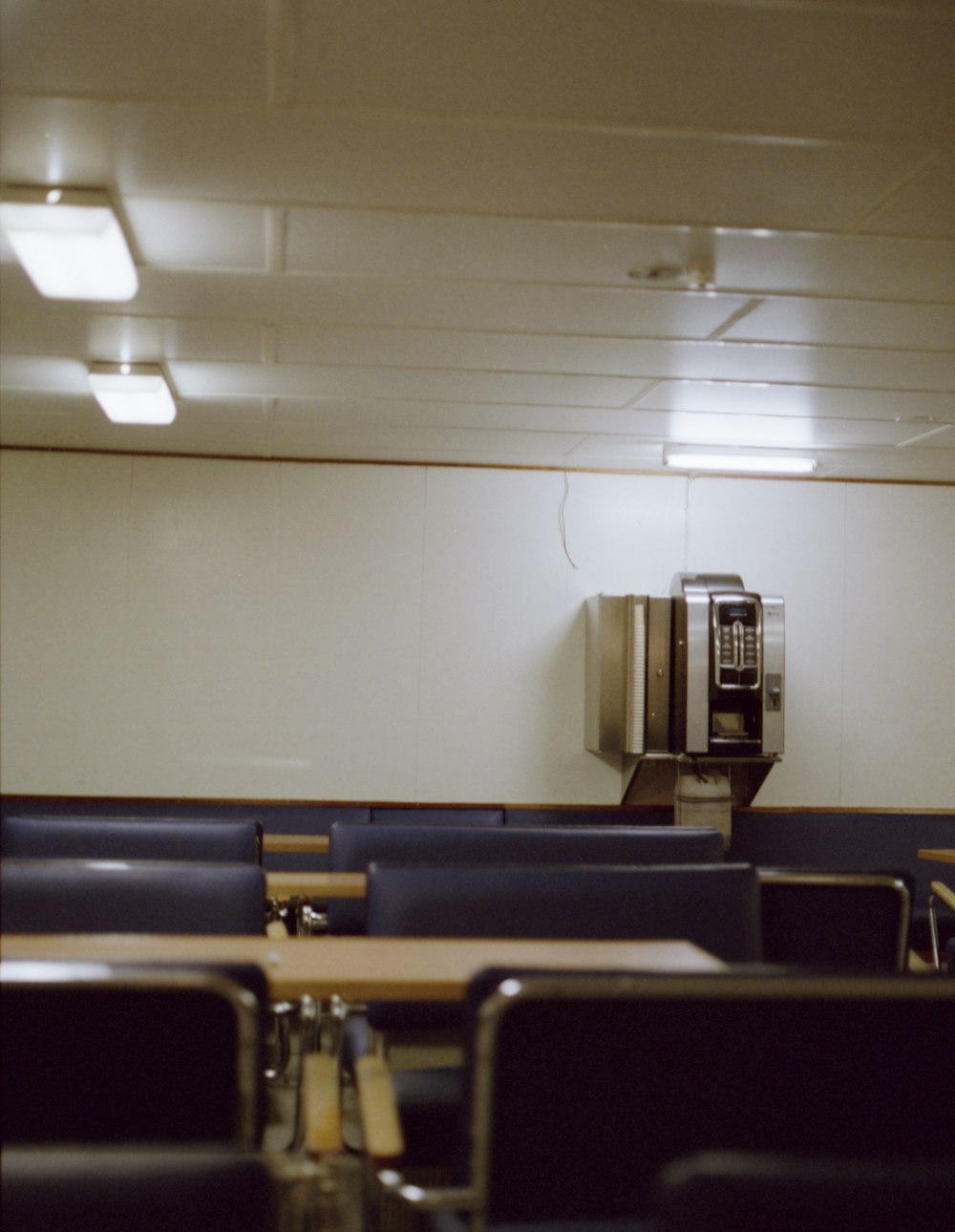 a room with a whiteboard and chairs