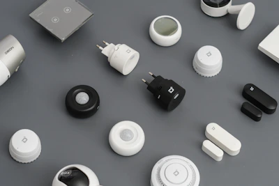 A variety of smart home devices arranged neatly on a wooden table.