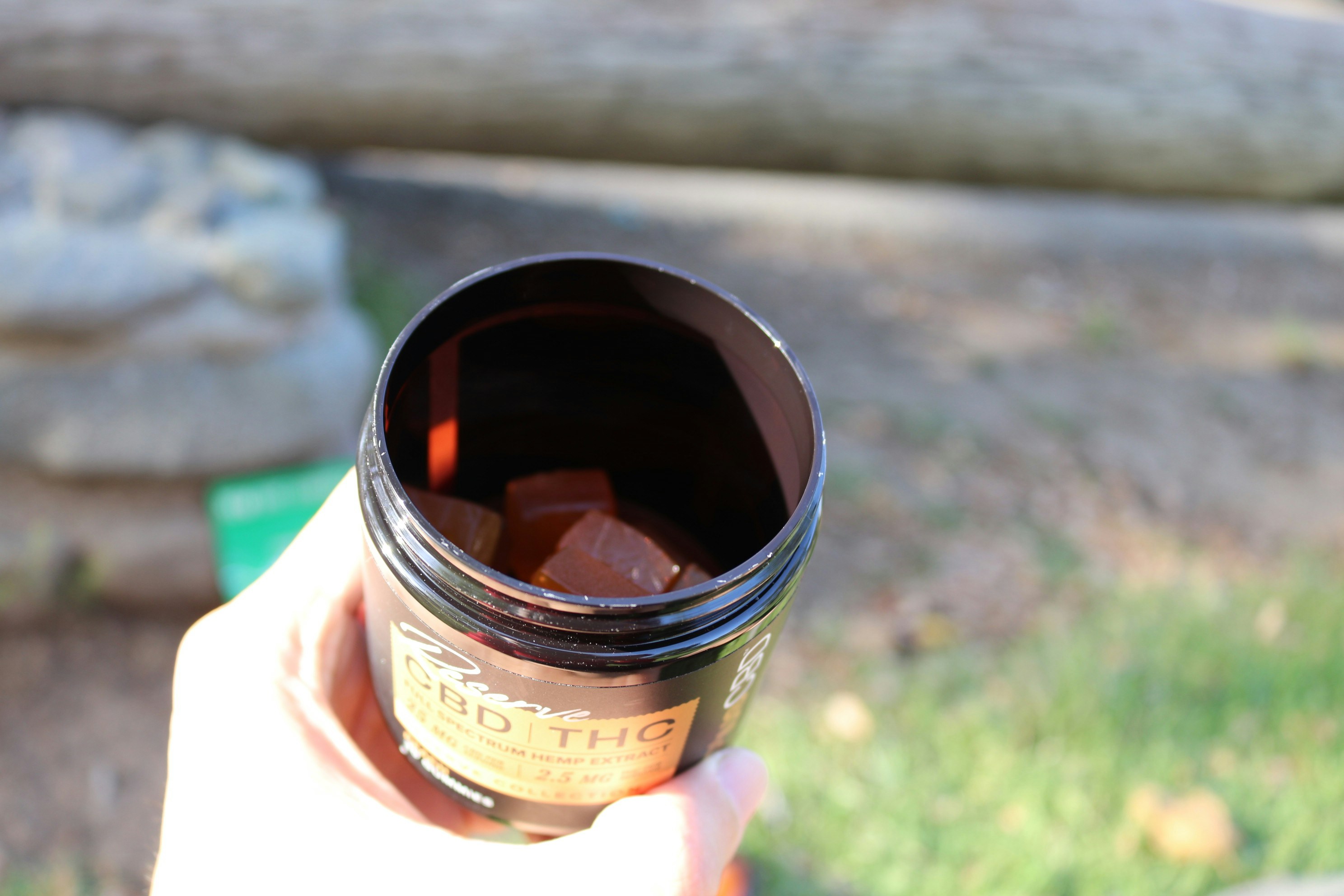 a hand holding a jar of jam