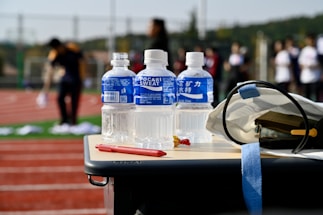 a table with a helmet and bottles of water on it