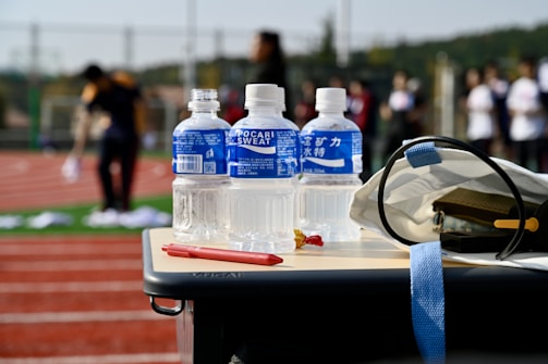 a table with a helmet and bottles of water on it