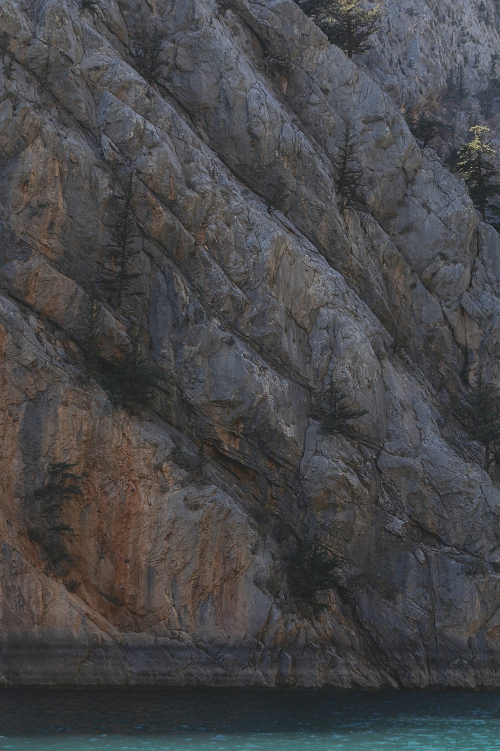 a cliff with a body of water below