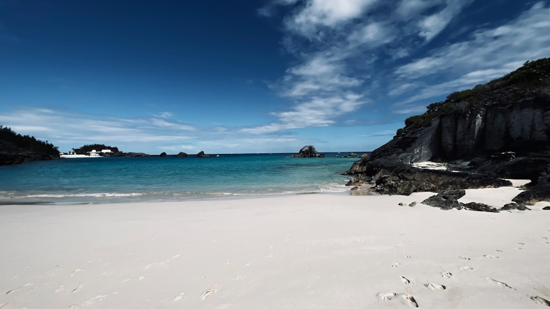 A Bermuda beach with rocks and water.