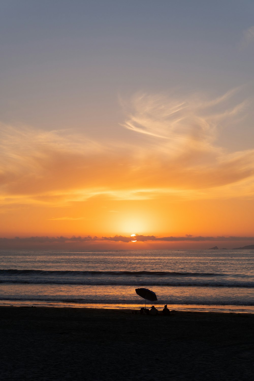 a person holding a surfboard on a beach