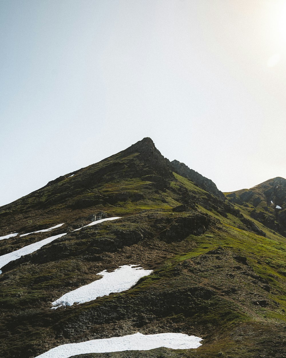 a mountain with a stream running through it