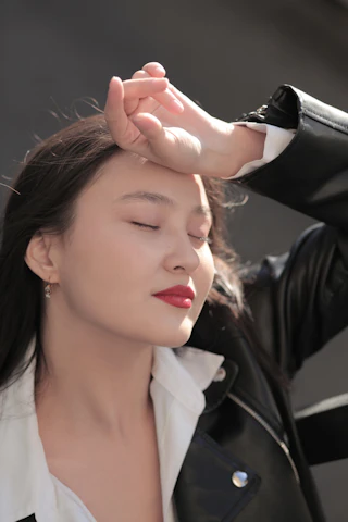 이마를 짚고 눈을 감은 여성